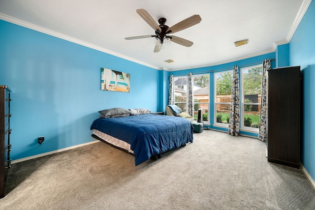 carpeted bedroom with ceiling fan and ornamental molding