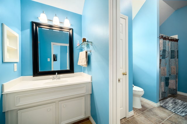 bathroom featuring toilet, vanity, and a shower with shower curtain