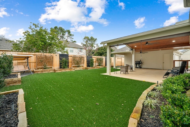 view of yard with ceiling fan and a patio area