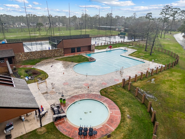 view of pool featuring a patio and a yard