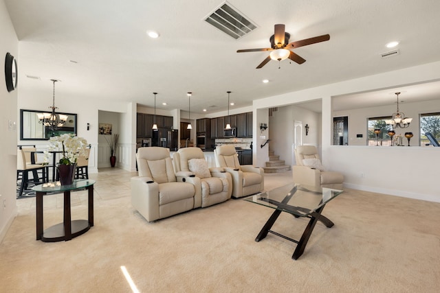 carpeted living room with ceiling fan with notable chandelier