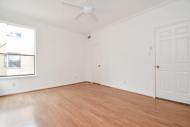 empty room with light wood-type flooring, ceiling fan, and ornamental molding