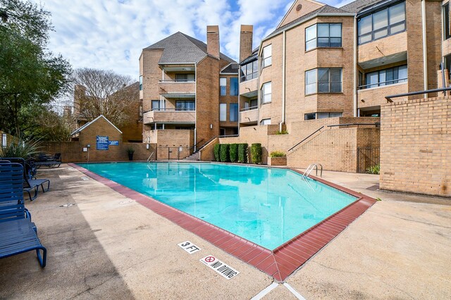 pool featuring a patio area and fence