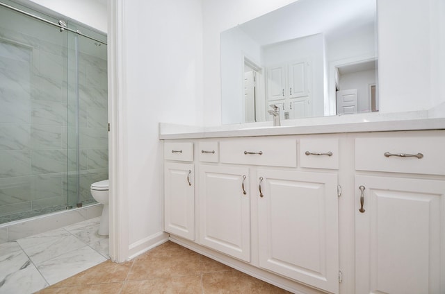 bathroom with toilet, a shower with door, and vanity