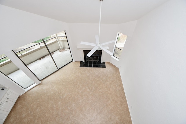 interior space with lofted ceiling and ceiling fan