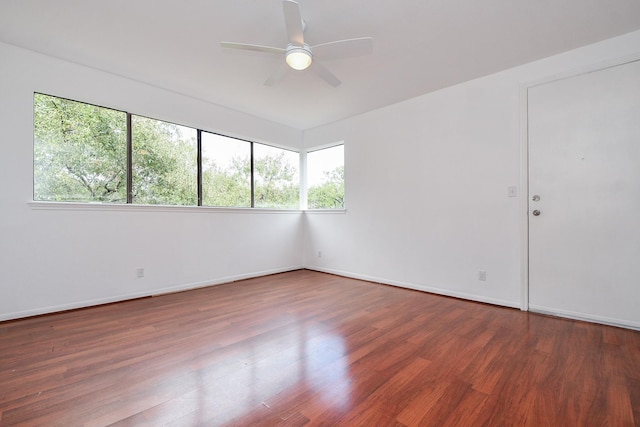 unfurnished room with ceiling fan and dark hardwood / wood-style floors