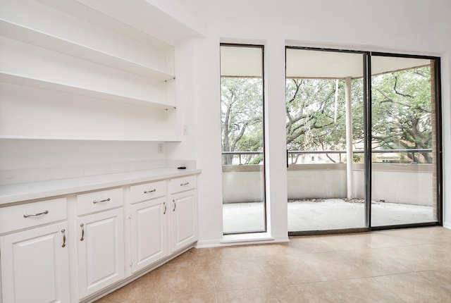 doorway with light tile patterned floors