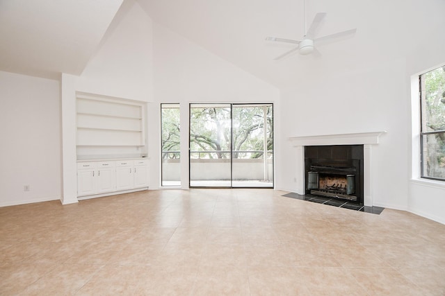 unfurnished living room with a fireplace, ceiling fan, light tile patterned floors, built in features, and high vaulted ceiling