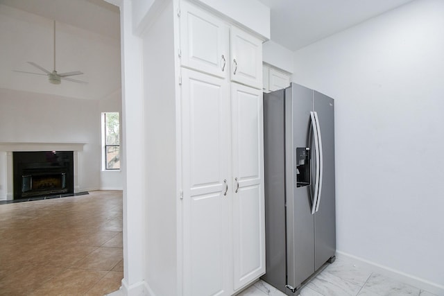 kitchen featuring lofted ceiling, white cabinets, ceiling fan, and stainless steel refrigerator with ice dispenser