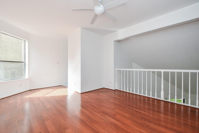 empty room with hardwood / wood-style flooring and ceiling fan