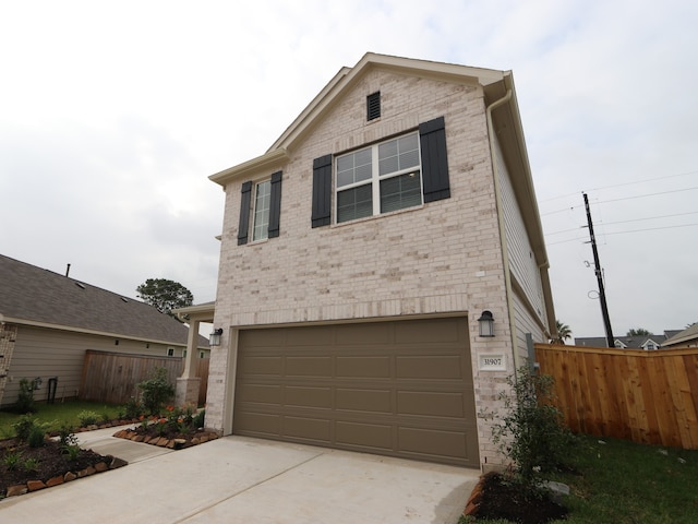 31907 Splendor Dr, Fulshear, TX 77441 - view of front of house with an attached garage, brick siding, and concrete driveway