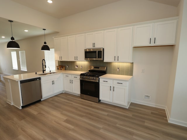 31907 Splendor Dr, Fulshear, TX 77441 - kitchen featuring stainless steel appliances, a sink, white cabinets, backsplash, and recessed lighting