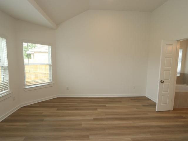 31907 Splendor Dr, Fulshear, TX 77441 - empty room featuring lofted ceiling, wood finished floors, and baseboards
