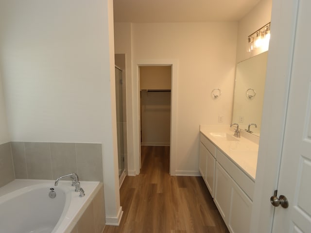 31907 Splendor Dr, Fulshear, TX 77441 - bathroom with a stall shower, a garden tub, double vanity, and wood finished floors
