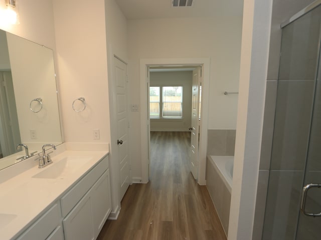 31907 Splendor Dr, Fulshear, TX 77441 - full bath with wood finished floors, double vanity, a garden tub, and a shower with shower door