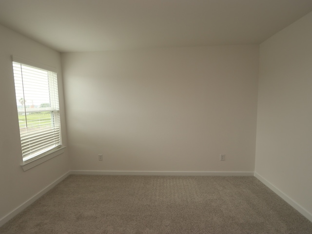 31907 Splendor Dr, Fulshear, TX 77441 - spare room featuring light carpet and baseboards