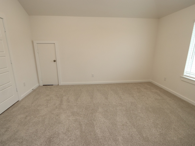 31907 Splendor Dr, Fulshear, TX 77441 - spare room with light colored carpet, lofted ceiling, and baseboards