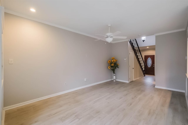 unfurnished room with light wood finished floors, stairway, ornamental molding, a ceiling fan, and baseboards