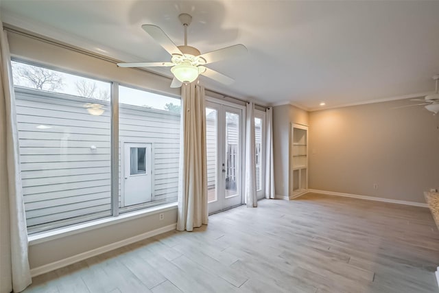 unfurnished room with french doors, a healthy amount of sunlight, and wood finished floors