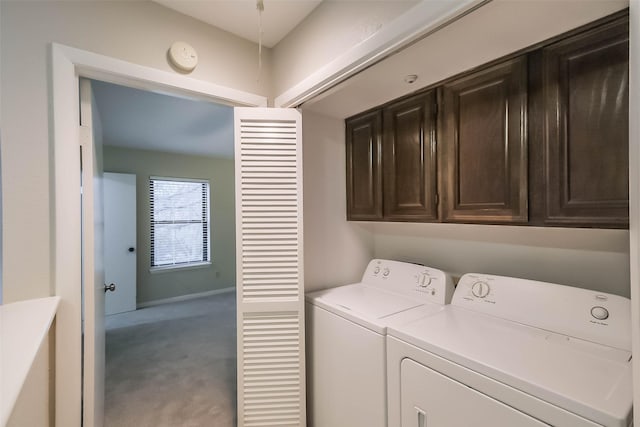 clothes washing area with carpet flooring, cabinet space, and washer and dryer