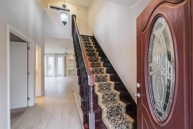 entrance foyer featuring stairway and wood finished floors