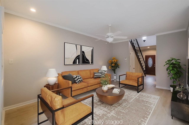 living area featuring stairs, ceiling fan, light wood finished floors, and baseboards