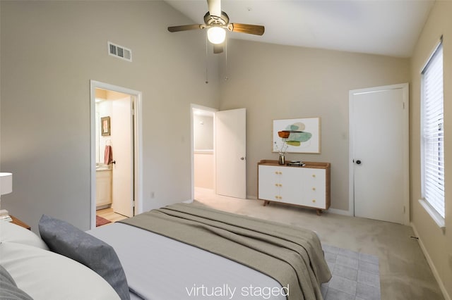 bedroom with light colored carpet, visible vents, ensuite bath, and multiple windows