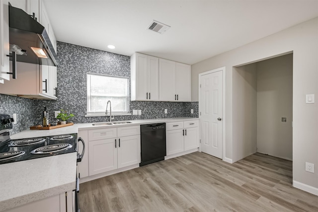 kitchen with sink, white cabinetry, black appliances, and light hardwood / wood-style floors