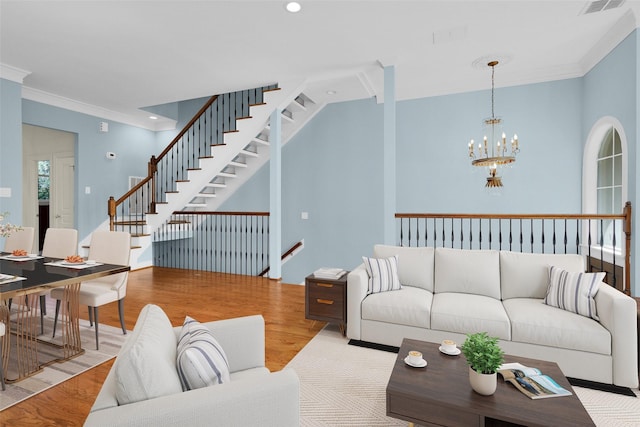 living room with stairs, wood finished floors, a chandelier, ornamental molding, and recessed lighting