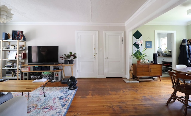 living room with crown molding and dark wood-type flooring