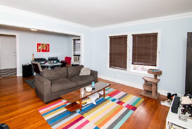 living area with baseboards, dark wood-type flooring, and crown molding