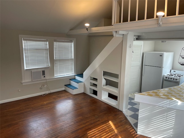 living area featuring dark wood-type flooring, vaulted ceiling, baseboards, and stairs