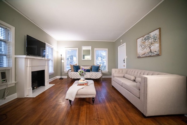 living area featuring a fireplace with flush hearth, dark wood-style flooring, crown molding, and baseboards