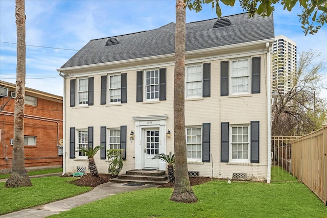 view of front of house featuring crawl space, roof with shingles, fence, and brick siding