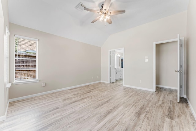 unfurnished bedroom featuring ceiling fan, lofted ceiling, light hardwood / wood-style floors, and ensuite bath