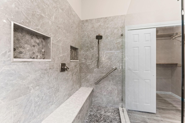 bathroom with tiled shower