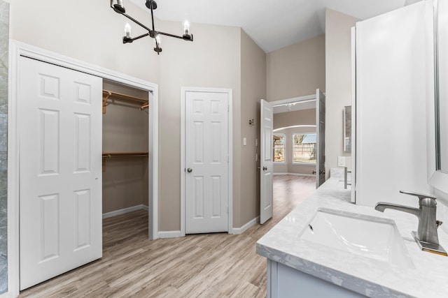 bathroom featuring vanity, a chandelier, and hardwood / wood-style floors