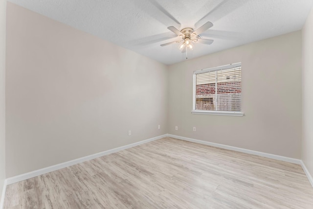 unfurnished room featuring light hardwood / wood-style flooring, ceiling fan, and a textured ceiling