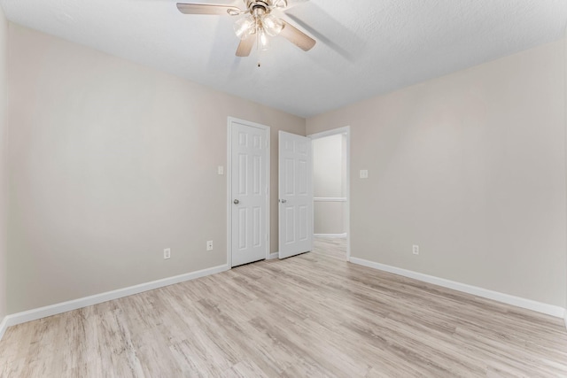 unfurnished room featuring ceiling fan, a textured ceiling, and light hardwood / wood-style floors