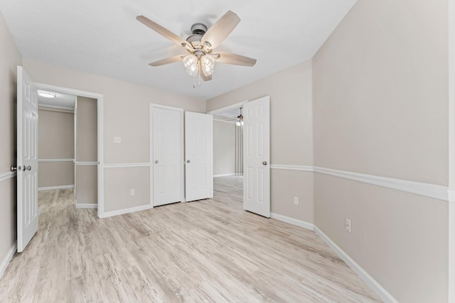 unfurnished bedroom with light hardwood / wood-style floors, a closet, and ceiling fan