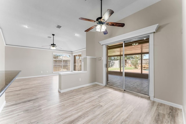 unfurnished living room with ceiling fan, vaulted ceiling, and light hardwood / wood-style floors