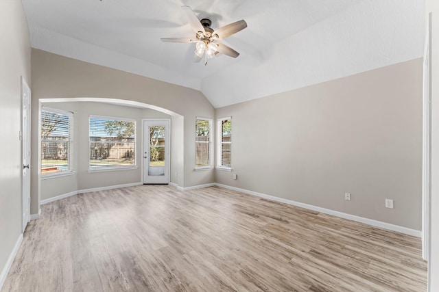 unfurnished room with light wood-type flooring, lofted ceiling, and ceiling fan