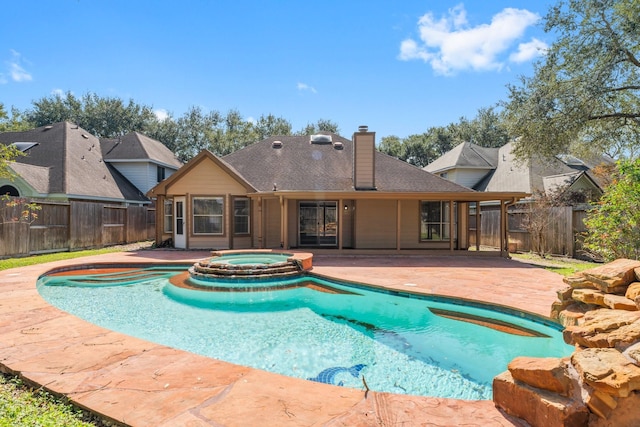 view of swimming pool with a patio area and an in ground hot tub