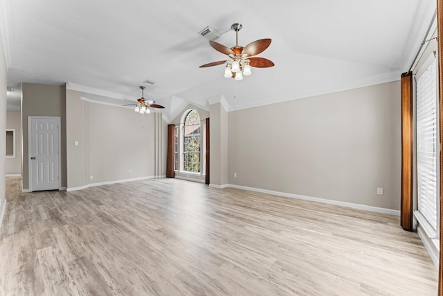 empty room featuring ceiling fan, light hardwood / wood-style flooring, crown molding, and lofted ceiling