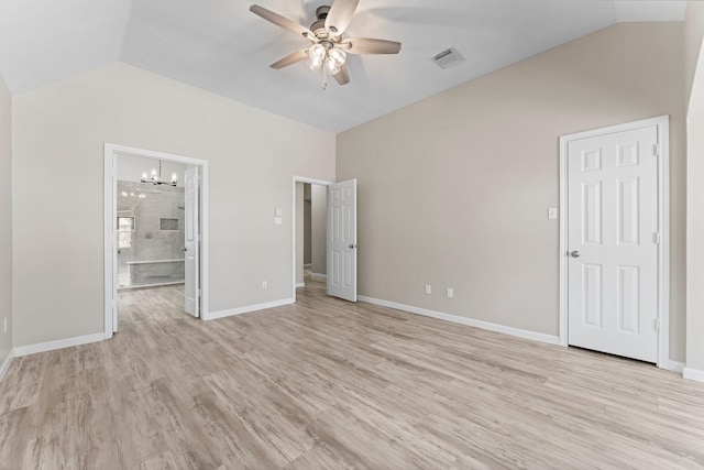 unfurnished bedroom featuring ceiling fan with notable chandelier, light hardwood / wood-style floors, lofted ceiling, and ensuite bath