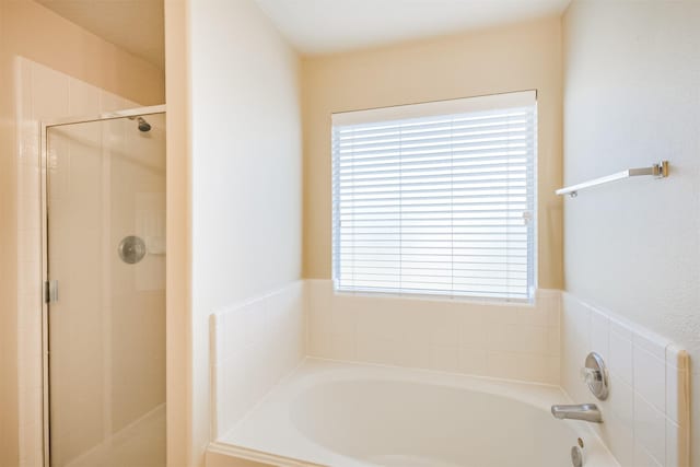 bathroom with separate shower and tub