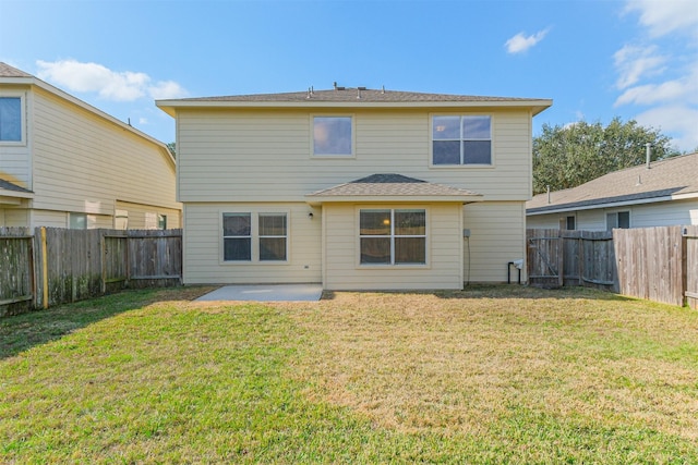 rear view of property featuring a patio and a lawn