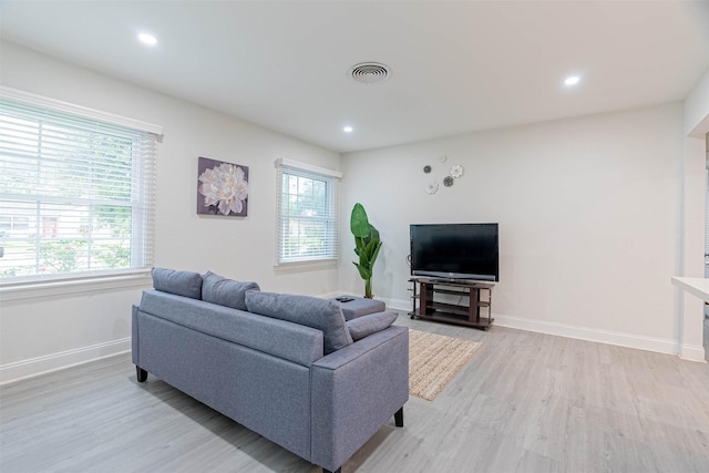 living room featuring plenty of natural light and light hardwood / wood-style flooring