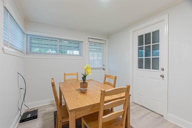 dining room with a healthy amount of sunlight and light hardwood / wood-style flooring