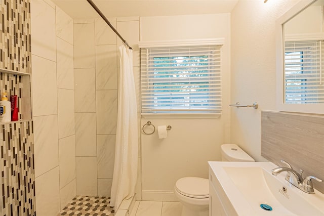 bathroom with toilet, vanity, a shower with shower curtain, and plenty of natural light